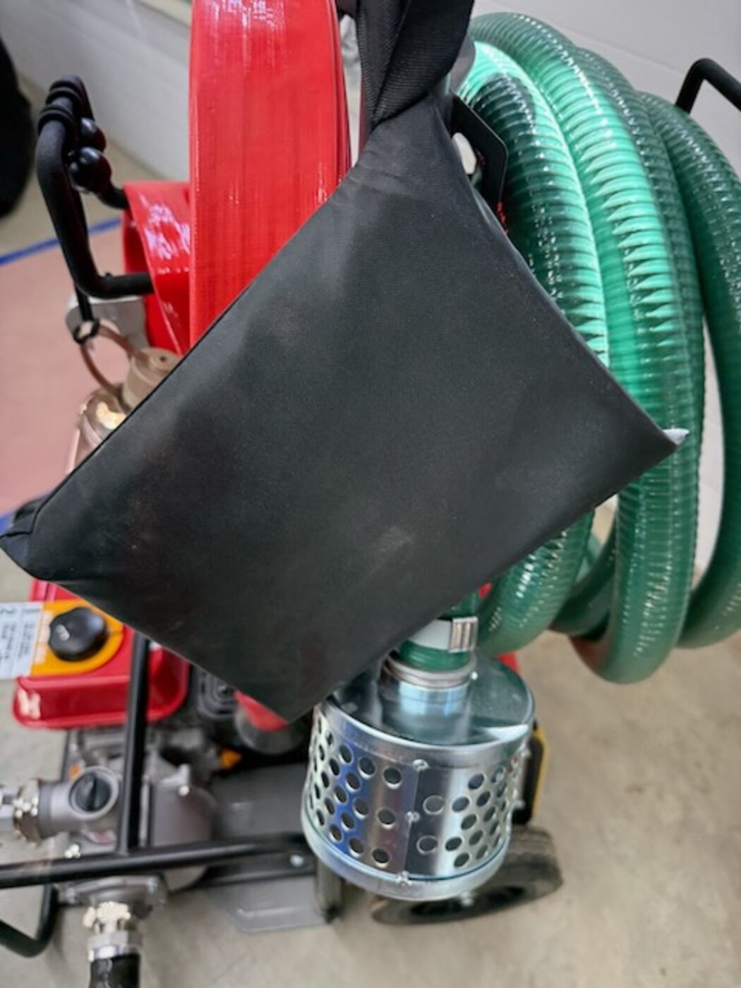 Weather-resistant storage pouch protecting the priming bottle on the FireReady HPS1