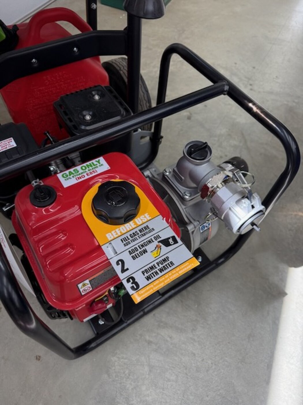 Close-up of the FireReady pump&rsquo;s quick-connect outlet fitting with a secured dust cap